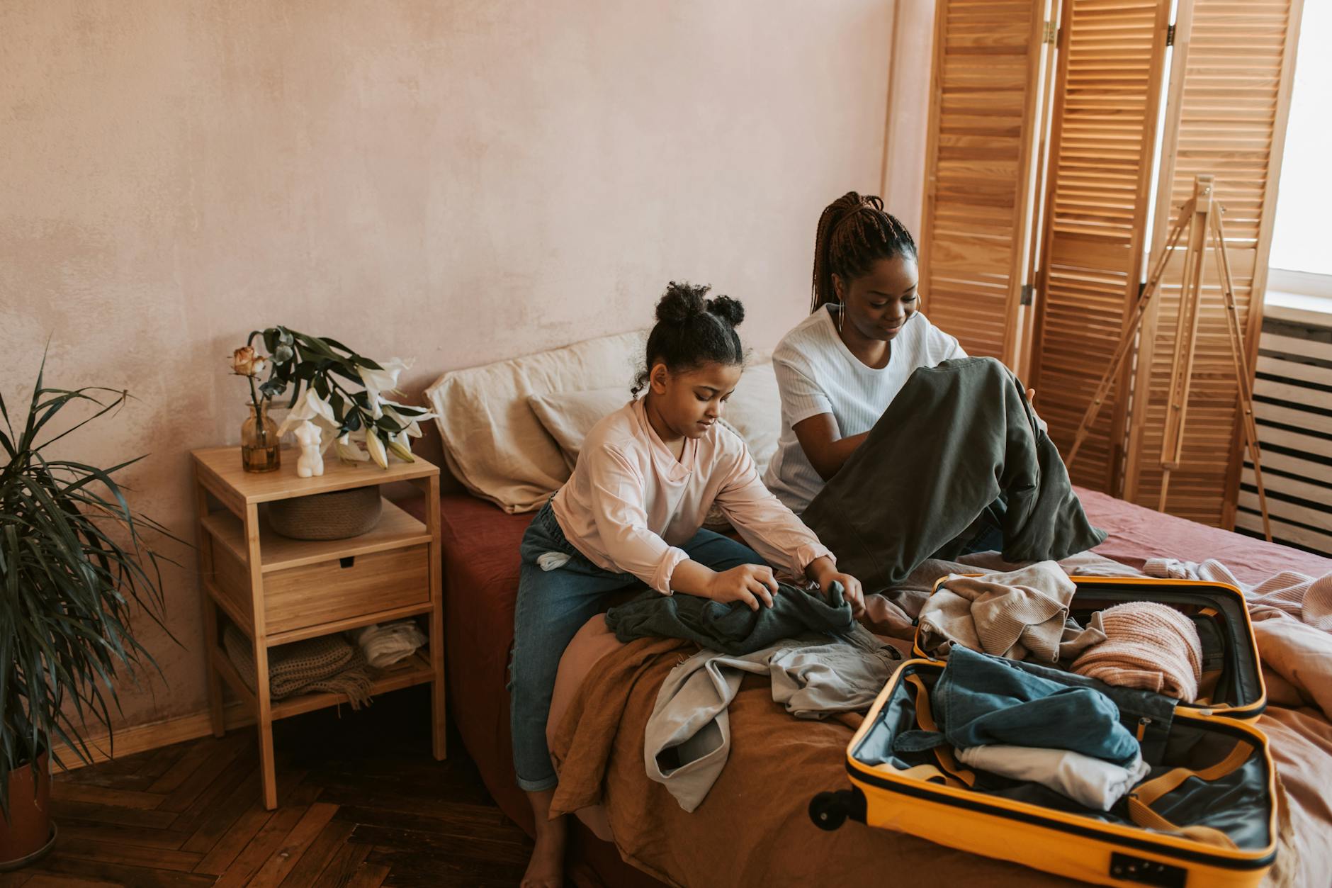 mother and daughter folding clothes