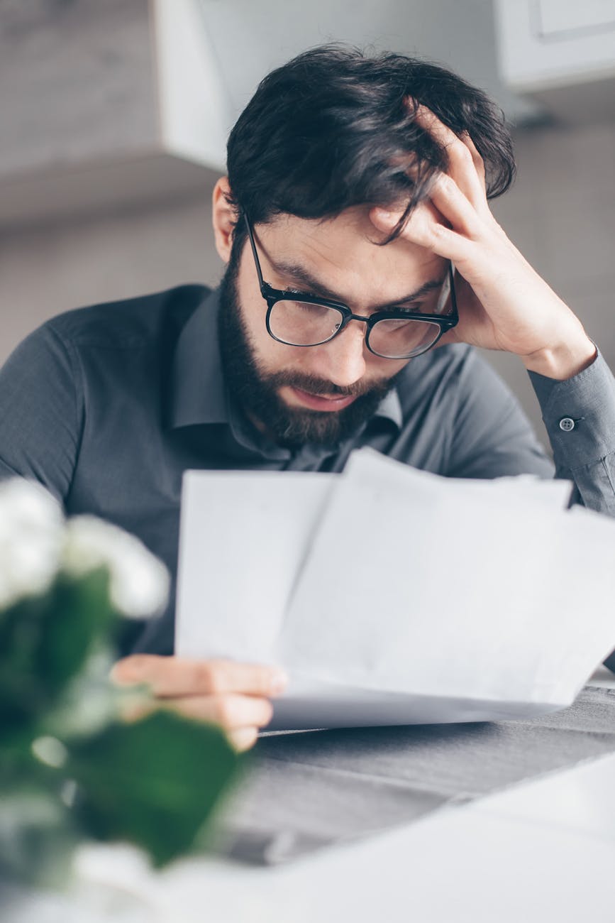 man in black long sleeve shirt holding white papers